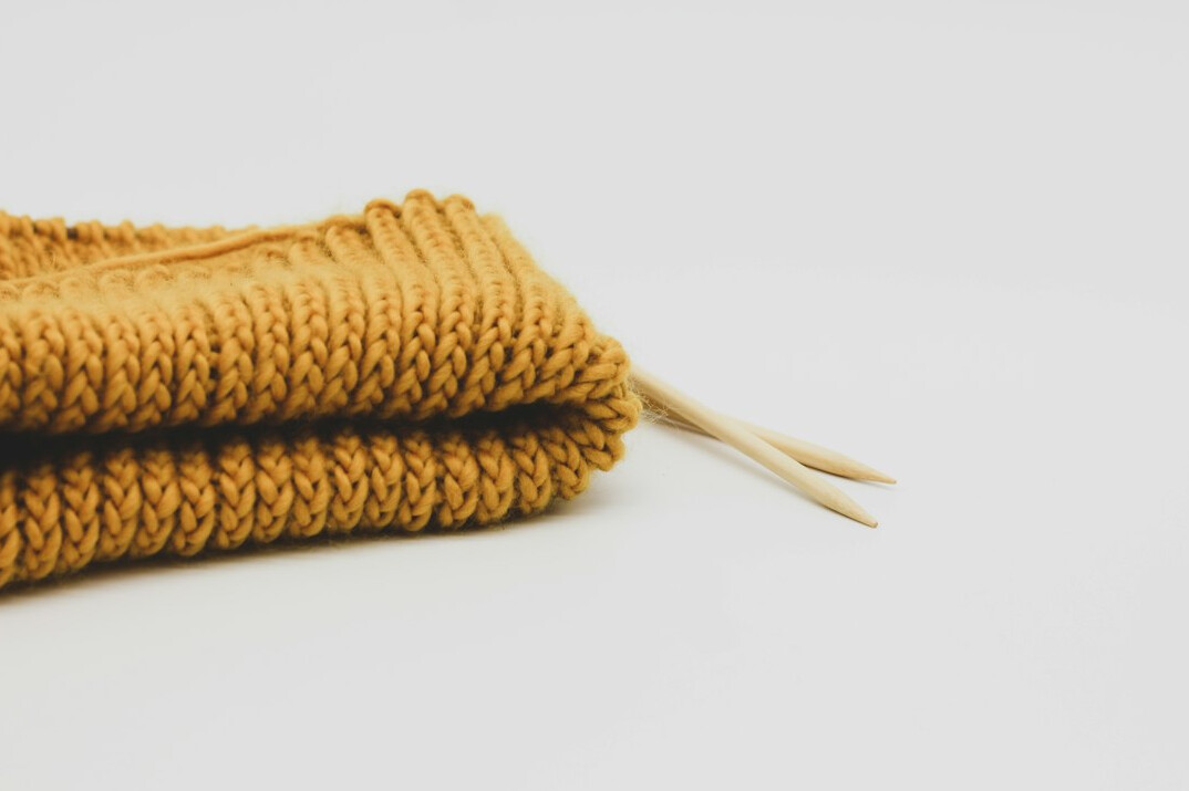 hands knitting wool scarf